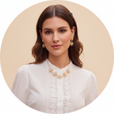 Circular portrait of Sophie Moore, a woman with a confident expression, wearing delicate AURELIA jewelry against a warm cream